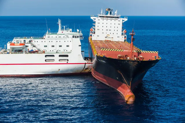 A handout photo made available by the Prefecture Maritime de la Mediterranee on 09 October 2018 shows operations to assist with cleanup efforts after a Tunisian ship and a Cypriot ship collided in the Mediterranean Sea north of Corsica island, 08 October 2018. French maritime authorities are working to contain an apparent oil spill. Italy and France have sent ships specialized in containing and cleaning up pollution spills to the scene. (Photo by Alexandre Groyer/EPA/EFE)