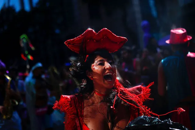 A person reacts as revellers take part in a block party called “Amores Liquidos”, during carnival festivities in Rio de Janeiro, Brazil April 21, 2022. (Photo by Amanda Perobelli/Reuters)