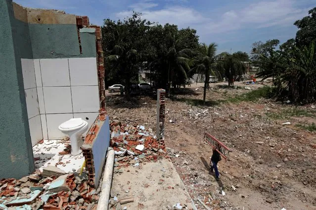 Partially demolished houses are seen in the Vila Autodromo slum in Rio de Janeiro, Brazil, February 25, 2016. (Photo by Ricardo Moraes/Reuters)