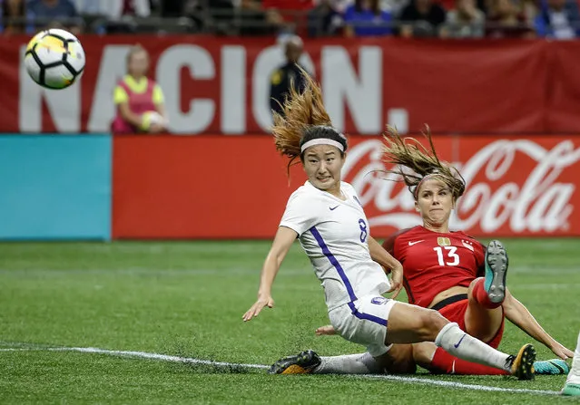 U. S. forward Alex Morgan (13) scores a goal as South Korea midfielder Cho Sohyun defends during the first half of an international friendly soccer match in New Orleans, Thursday, October 19, 2017. (Photo by Derick E. Hingle/USA TODAY Sports)