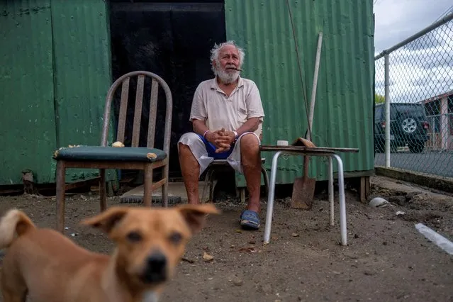 Luis Pacheco, 76, sits in front of his house as Hurricane Fiona and its heavy rains approaches in Guayanilla, Puerto Rico on September 18, 2022. (Photo by Ricardo Arduengo/Reuters)