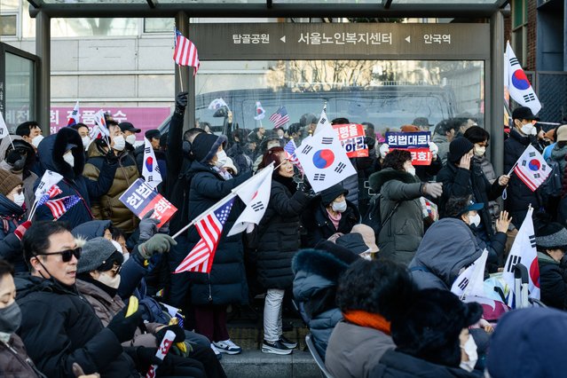 Supporters of South Korea's impeached President Yoon Suk Yeol attend a rally on a road near the Constitutional Court in Seoul on January 23, 2025, after Yoon arrived at the court for hearings that will decide whether to remove him from office. (Photo by Anthony Wallace/AFP Photo)
