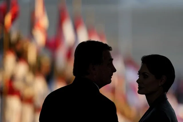 Brazil's President Jair Bolsonaro and his wife Michelle Bolsonaro stand together during the ceremony to receive the reliquary containing the heart of Brazil's former emperor Dom Pedro I, at the Planalto Presidential Palace, in Brasilia, Brazil, Tuesday, August 23, 2022. The heart arrived for display during the celebrations of Brazil's independence bicentennial on Sept. 7. (Photo by Eraldo Peres/AP Photo)