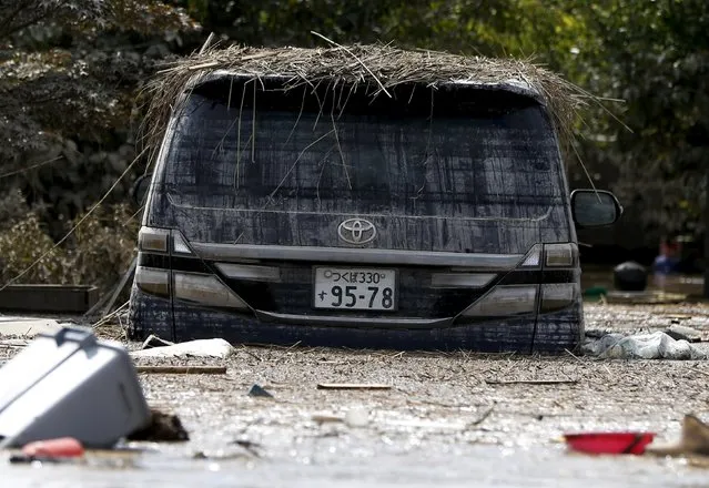 A damaged Toyota Motor car is seen at a residential area flooded by the Kinugawa river, caused by Typhoon Etau at Araigi town in Joso, Ibaraki prefecture, Japan, September 12, 2015. (Photo by Issei Kato/Reuters)