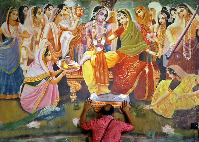 A man prays inside an ISKCON temple after the opening of most of the religious places after India eases lockdown restrictions that were imposed to slow the spread of the coronavirus disease (COVID-19), in Ahmedabad, India, June 8, 2020. (Photo by Amit Dave/Reuters)