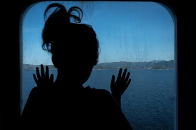 Bianca Toniolo, 3, looks out of a window onboard a ferry to try and look for mermaids as she travels to the island of Sardinia to see her grandparents, after leaving the region of Lombardy for the first time since her hometown became a red zone in February, in this picture taken at sea by her father Marzio Toniolo, June 3, 2020. (Photo by Marzio Toniolo/Reuters)