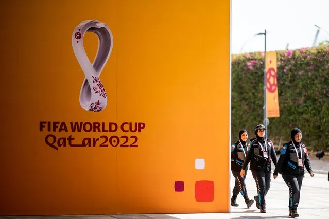 Policewomen walk past FIFA World Cup signs as they arrive at the Main Media Center (MMC) in Doha on October 31, 2022, ahead of the Qatar 2022 FIFA World Cup football tournament. (Photo by Jewel Samad/AFP Photo)