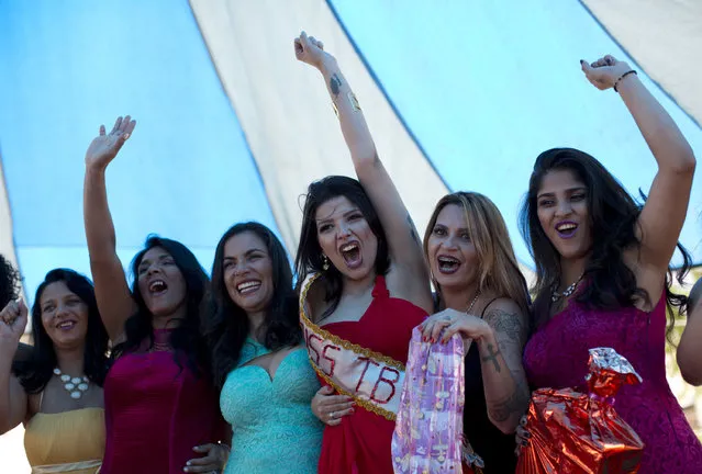 Inmate Mayana Rosa Alves, center, celebrates winning her jail's annual beauty contest at Talavera Bruce penitentiary in Rio de Janeiro, Brazil, early Thursday, November 23, 2017. “Everyone is very happy to be with their family. I feel nervous and at the same time happy. I just wish I had also won freedom and would have taken my sash with me out of here”, said Alves who is serving time for robbery. (Photo by Silvia Izquierdo/AP Photo)