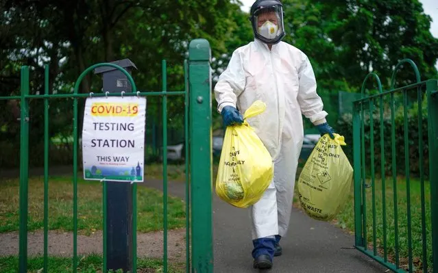 A city council worker carries rubbish from a coronavirus testing centre at Spinney Park which will be incinerated on June 29, 2020 in Leicester, England. In a television appearance on Sunday, British Home Secretary Priti Patel confirmed the government was considering a local lockdown after a spike in coronavirus cases in the city. The city's mayor has said that Pubs and restaurants in Leicester may stay closed for two more weeks due to a recent surge in coronavirus cases. (Photo by Christopher Furlong/Getty Images)