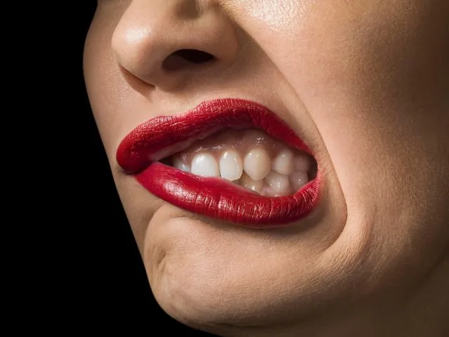 Female with red lipstick, grimacing, close up. (Photo by Jonathan Knowles/Getty Images)