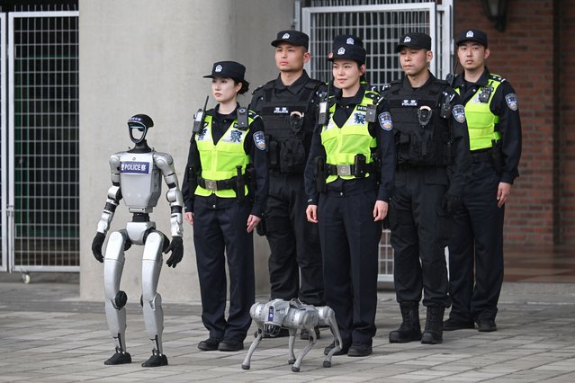 Chinese police officers, accompanied by a humanoid robot and a robot dog, are seen during the Formula One Chinese Grand Prix at the Shanghai International Circuit in Shanghai on March 23, 2025. (Photo by Jade Gao/AFP Photo)