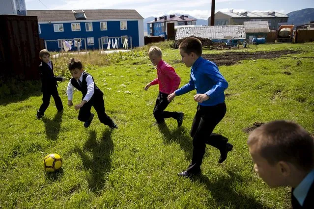Boys play football after school in Yuzhno-Kurilsk, the main settlement on the Southern Kurile island of Kunashir September 14, 2015. (Photo by Thomas Peter/Reuters)