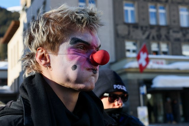 A protester reacts, as climate activists and anti-WEF (World Economic Forum) demonstrators take part in a protest ahead of the opening of the WEF annual meeting in Davos, Switzerland on January 14, 2024. (Photo by Denis Balibouse/Reuters)