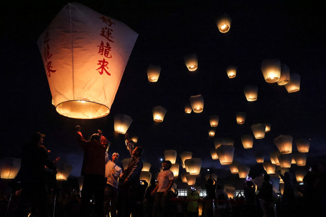 Tourists release sky lanterns during the Pingxi Lantern Festival in New Taipei City on February 17, 2024. (Photo by I-Hwa Cheng/AFP Photo)
