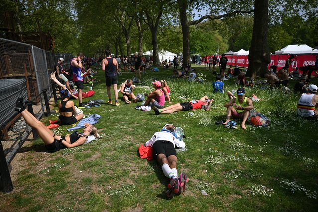 Runners relax after finishing the 2025 London Marathon in central London on April 27, 2025. (Photo by Justin Tallis/AFP Photo)
