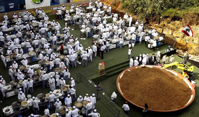 Chefs fry falafel balls before adding them to a giant plate in an attempt to set a new Guinness world record in Beirut on May 9, 2010. A day after regaining the world record for the largest plate of hummus, Lebanon set a new record for the largest serving of falafel; it weighed about 11,400 pounds. (Photo by Anwar Amro/AFP Photo)