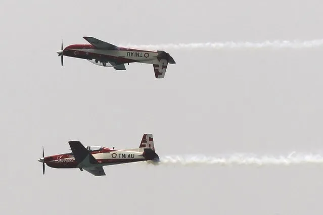 Two Wong Bee airplanes from the Jupiter Aerobatic Team of Indonesia Air Force fly perform during a rehearsal for a ceremony marking the 70th anniversary of Indonesia's military in Cilegon, Banten province, October 3, 2015. (Photo by Reuters/Beawiharta)