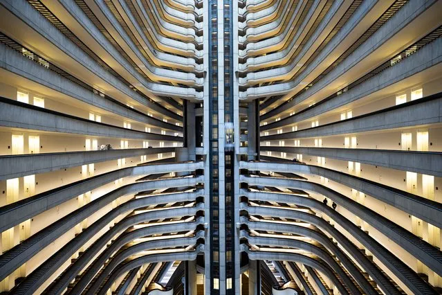 Hotel guests walk through the Marriott Marquis hotel in Atlanta, Georgia, USA, 06 December 2022. Brutalism is a modern architectural style derived from the term 'Beton brut' coined by British architectural theorist Reyner Banham in the 1950s. Characteristics are the use of exposed concrete and the visibility of the structure. (Photo by Jim Lo Scalzo/EPA/EFE)