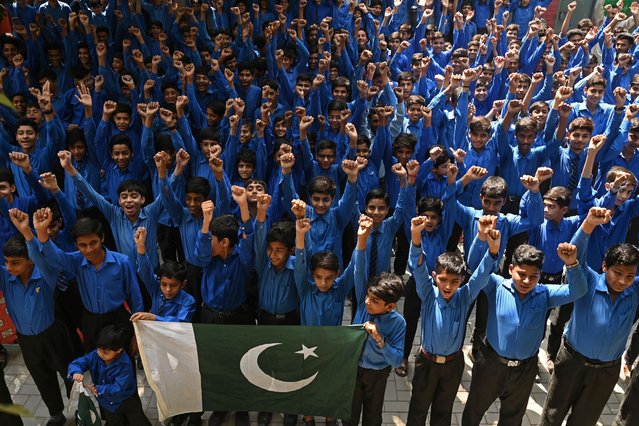 Students shout slogans as they express solidarity with Pakistan's armed forces during a school assembly in Lahore on May 12, 2025, after schools reopened following a ceasefire between Pakistan and India. Indian and Pakistani military chiefs were set to confer on May 12 as a ceasefire that brought the nuclear-armed rivals back from the brink of all-out war held. (Photo by Arif Ali/AFP Photo)