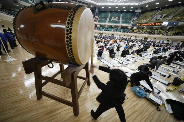 A staff beats a drum to start the annual New Year's calligraphy contest at the Budokan martial arts hall Thursday, January 5, 2023, in Tokyo. (Photo by Eugene Hoshiko/AP Photo)
