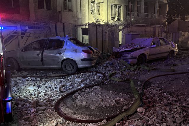 Destroyed vehicles are pictured outside a building a that was hit by an Israeli strike in Tehran on June 13, 2025. Israel hit about 100 targets in Iran on June 13, including nuclear facilities and military command centres and killing senior figures including the armed forces chief and top nuclear scientists. (Photo by Meghdad Madadi/Tasnim News via AFP Photo)