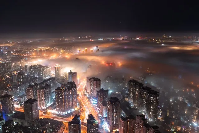Aerial view of buildings surrounded by advection fog on January 14, 2023 in Xiamen, Fujian Province of China. (Photo by VCG/VCG via Getty Images)