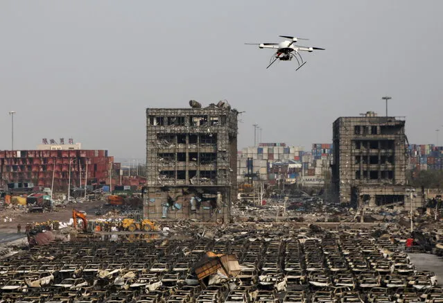 A drone operated by paramilitary police flies over the site the explosions at Binhai new district in Tianjin, China, August 17, 2015. (Photo by Kim Kyung-Hoon/Reuters)