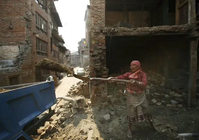 A woman works to rebuild a house a year after the 2015 earthquakes in Bhaktapur, Nepal, April 25, 2016. (Photo by Navesh Chitrakar/Reuters)