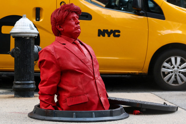 A sculpture of U.S. President Donald Trump emerging from a manhole, created by artist James Colomina, is displayed in Manhattan on July 23, 2025. (Photo by Kylie Cooper/Reuters)
