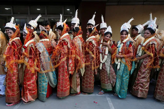Brides wait to take their vows at a mass wedding ceremony organised on the occasion of Valentine's Day, in Kolkata, India February 14, 2018. (Photo by Rupak De Chowdhuri/Reuters)