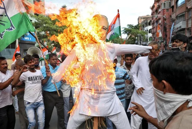 Supporters of India's main opposition Congress party burn an effigy of Prime Minister Narendra Modi during a protest march after the death of a rape victim, in Kolkata, India, October 1, 2020. (Photo by Rupak De Chowdhuri/Reuters)