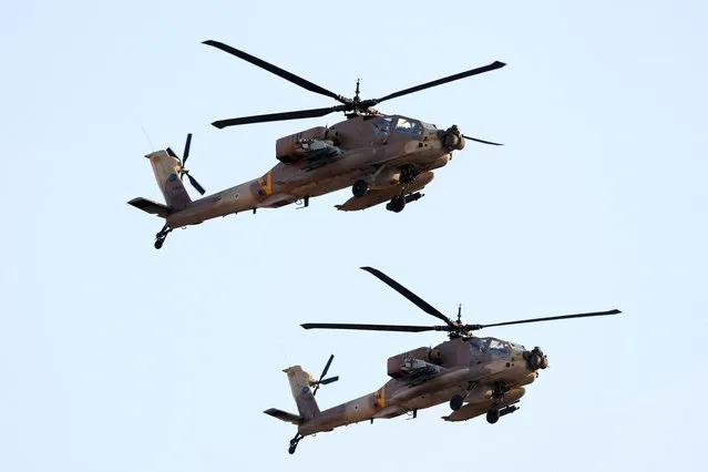 Israeli AH-64 Apache longbow helicopters perform during a graduation ceremony of Israeli Air Force pilots, at the Hatzerim base in the Negev desert, near the southern city of Beer Sheva, on December 28, 2022. (Photo by Jack Guez/AFP Photo)