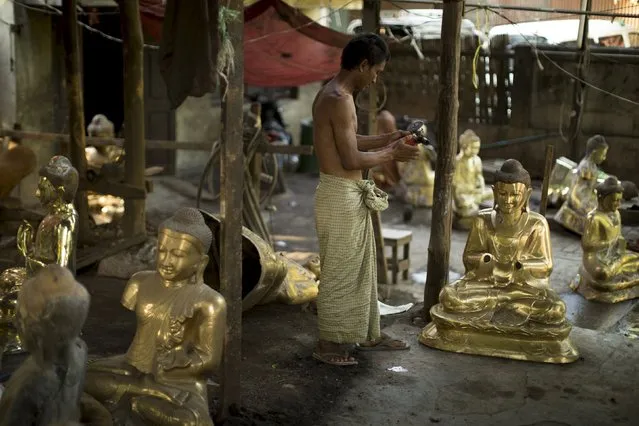 A man works on Buddha statues near Mahamuni Buddhist temple in Mandalay October 6, 2015. (Photo by Jorge Silva/Reuters)