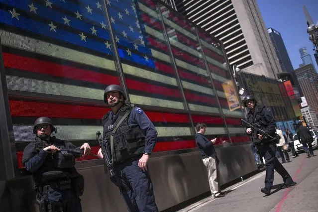 Members of the New York Police Department Hercules team stand in front of a large electronic U.S. flag while patroling the streets of Times Square in Midtown, New York, April 26, 2013. New York City officials said on Thursday that Boston Marathon bombing suspect Dzhokhar Tsarnaev told investigators in the hospital that after the FBI released their pictures, the pair made an impromptu plan to drive to New York and set off more bombs in Times Square. New York has been on heightened alert since the Sept. 11, 2001, attacks. (Photo by Shannon Stapleton/Reuters)