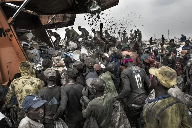 Environment, first prize stories: Kadir van Lohuizen, the Netherlands. Wasteland: People wait to sort through waste for recyclable and saleable material, as a garbage truck arrives at the Olusosun landfill, in Lagos, Nigeria, January 21, 2017. Humans are producing more waste than ever before. According to research by the World Bank, the world generates 3.5 million tonnes of solid waste a day, ten times the amount of a century ago. Rising population numbers and increasing economic prosperity fuel the growth, and as countries become richer, the composition of their waste changes to include more packaging, electronic components and broken appliances, and less organic matter. Landfills and waste dumps are filling up, and the World Economic Forum reports that by 2050 there will be so much plastic floating in the world’s oceans that it will outweigh the fish. A documentation of waste management systems in metropolises across the world investigates how different societies manage – or mismanage – their waste. (Photo by Kadir van Lohuizen/NOOR Images/World Press Photo)