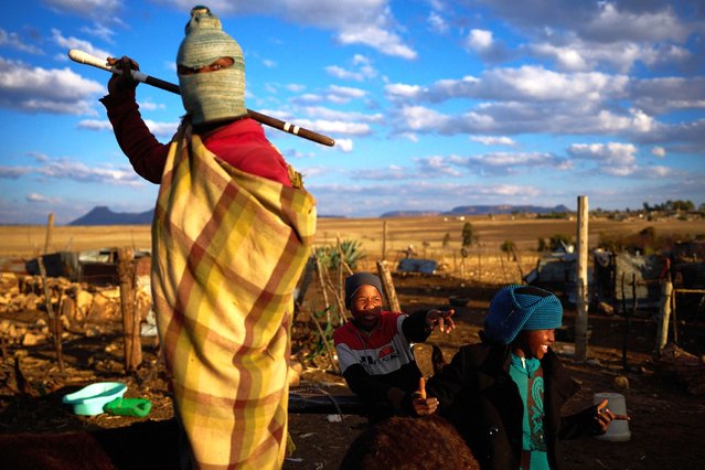 Boys stand outside their homes after a day of work in Mafeteng, Lesotho, July 12, 2025. (Photo by Bram Janssen/AP Photo)
