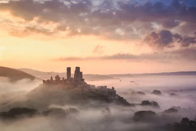Corfe Castle, Dorset, UK, 2016. Corfe Castle, in the Purbeck Hills between Swanage and Wareham, is one of the most romantic ruins in the UK and autumn sees this area at its best. Morning mists are common and walks in the hills provide the perfect vantage points to look down on the castle and across the heathland to Poole harbour. (Photo by Mark Bauer)