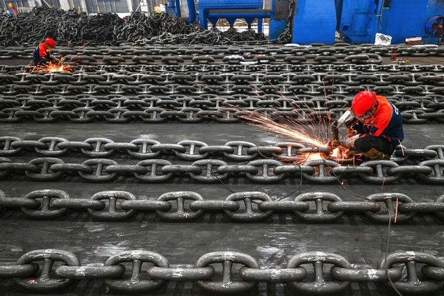 Employees manufacture anchor chains on the production line at Zhongyun Marine Equipment in Suqian, in eastern China's Jiangsu province on October 21, 2025. (Photo by AFP Photo/China Stringer Network)