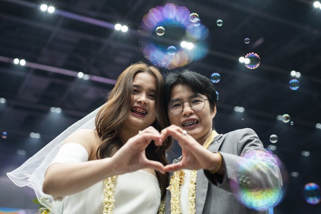 Wasana liamyongyai (L) and Niramol pongkan (R), a same-s*x couple, pose during their marriage registration event at Paragon shopping mall in Bangkok on January 23, 2025. A high-profile gay couple married in Thailand on January 23 as the kingdom's same-s*x marriage law went into effect, an AFP journalist saw, among the first of hundreds expected to do so. (Photo by Chanakarn Laosarakham/AFP Photo)