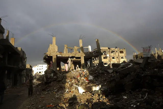 A picture taken on January 8, 2015 shows a rainbow over buildings that were destroyed during the 50-day war between Israel and Hamas-led militants, in Gaza City's al-Shejaiya neighborhood. Hundreds of schools were closed across Israel and the Palestinian territories on January 7, 2015 as a major winter storm gripped the region, with snow expected in Jerusalem as well. (Photo by Mohammed Abed/AFP Photo)