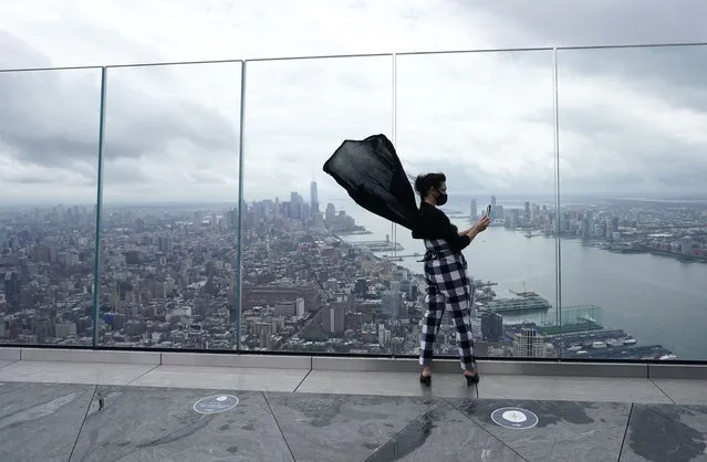 Anissa Barbato from New York looks out over the city as she takes pictures from the Edge, the highest outdoor sky deck in the Western Hemisphere on September 2, 2020 as it reopened to the public in New York. Rising 1,131 feet in the air from the heart of Hudson Yards it offers  360-degree views of New York Citys iconic skyline from the 100th floor outdoor viewing. (Photo by Timothy A. Clary/AFP Photo)