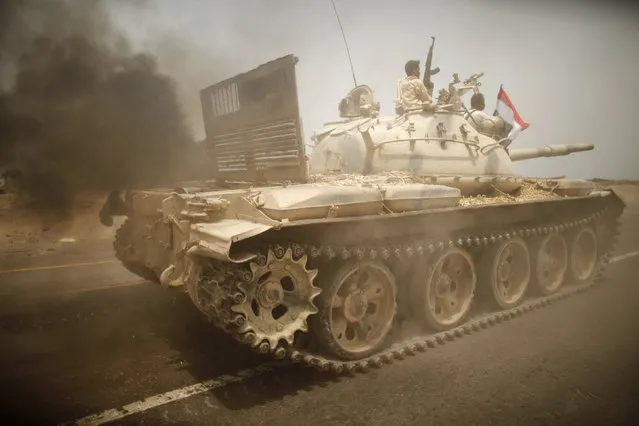 An army tank is driven on a road near the southern Yemeni city of Zinjibar June 14, 2012. (Photo by Khaled Abdullah/Reuters)