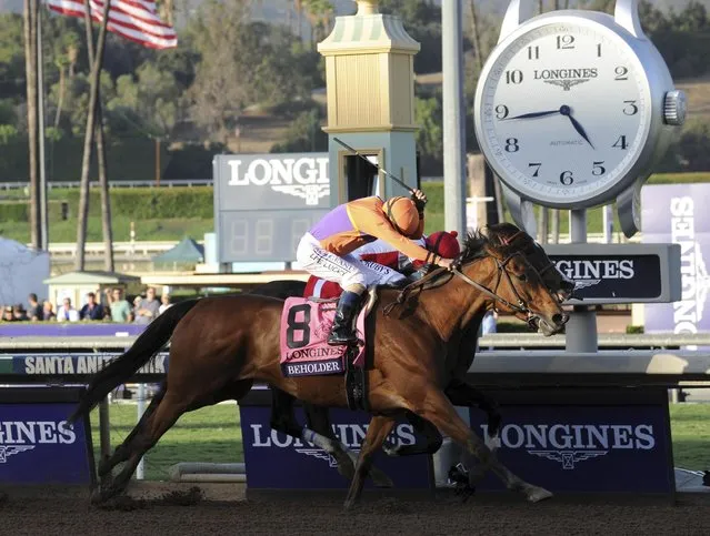 Jockey Gary Stevens, on Beholder, edges past Songbird to win the Longines Breeders' Cup Distaff, Friday, November 4, 2016, at Santa Anita Park in Arcadia, CA. (Photo by Diane Bondareff/Invision for Longines/AP Images)