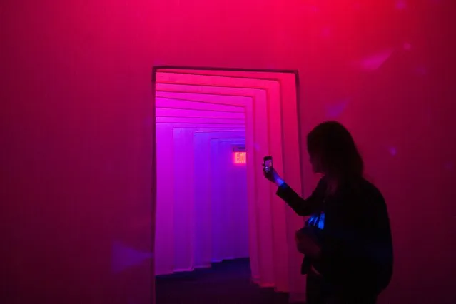 A person take a mobile phone photo of a corridor between galleries at the Museum of Feelings, a pop-up installation in New York, December 15, 2015. (Photo by Stephanie Keith/Reuters)