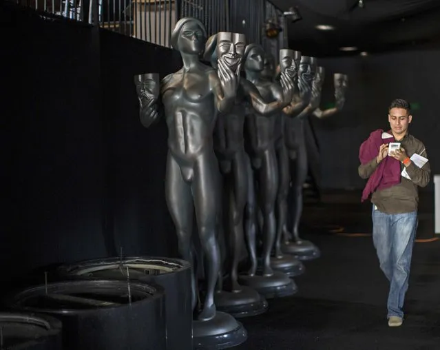 A person walks by statues of “The Actor” in preparation for the 21st annual Screen Actors Guild Awards at the Shrine Auditorium in Los Angeles, California January 22, 2015. The Awards will be given out in Los Angeles on January 25. (Photo by Mario Anzuoni/Reuters)