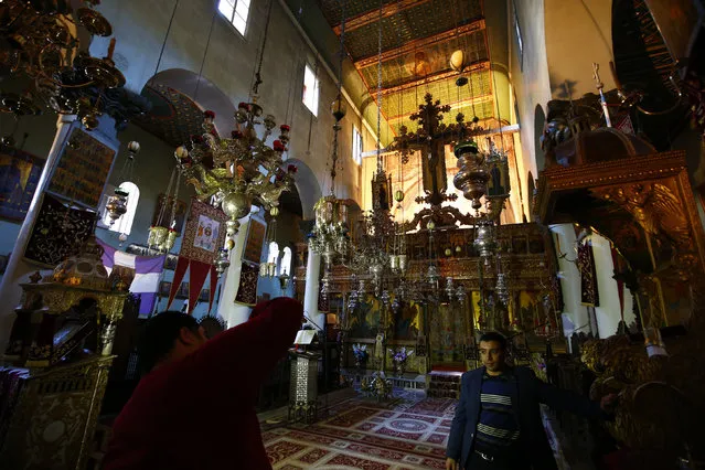 Egyptian muslims take a picture inside a church at Saint Catherine's monastery, in the Sinai Peninsula, south of Egypt, December 8, 2015. (Photo by Amr Abdallah Dalsh/Reuters)