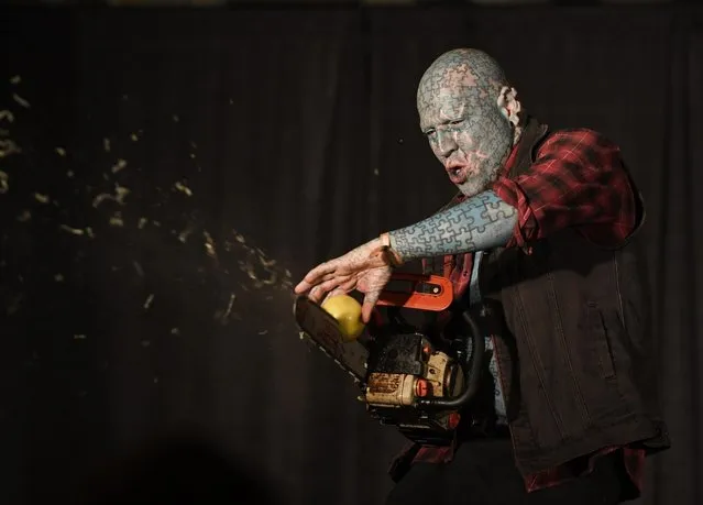 The Enigma sprays the crowd with shredded apple coming from a chainsaw in the Freak Show tent at the Denver County Fair on the National Western Stock Show grounds July 14, 2018. (Photo by Andy Cross/The Denver Post)