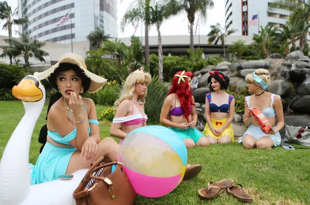 Cosplayers are dressed as the Disney princesses outside Comic-Con on July 20, 2018 at the San Diego Convention Center in San Diego, California. More than 100,000 are expected at the annual comic and entertainment convention. (Photo by Mario Tama/Getty Images)