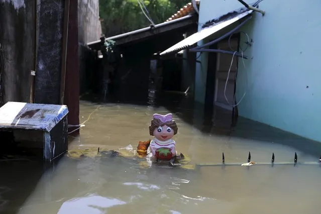A plastic doll is seen outside a house in a flooded neighborhood in Asuncion, Paraguay December 30, 2015. (Photo by Jorge Adorno/Reuters)