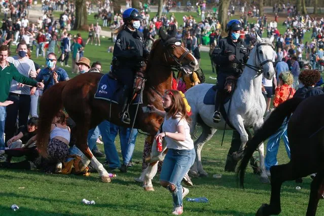 Police on horses try to disperse people as they take part in fake festival called “La Boum” organized by an anonymous group of people on Facebook for an April Fool's joke at the 'Bois de la Cambre, in Brussels, Belgium, 01 April 2021. (Photo by Stephanie Lecocq/EPA/EFE)
